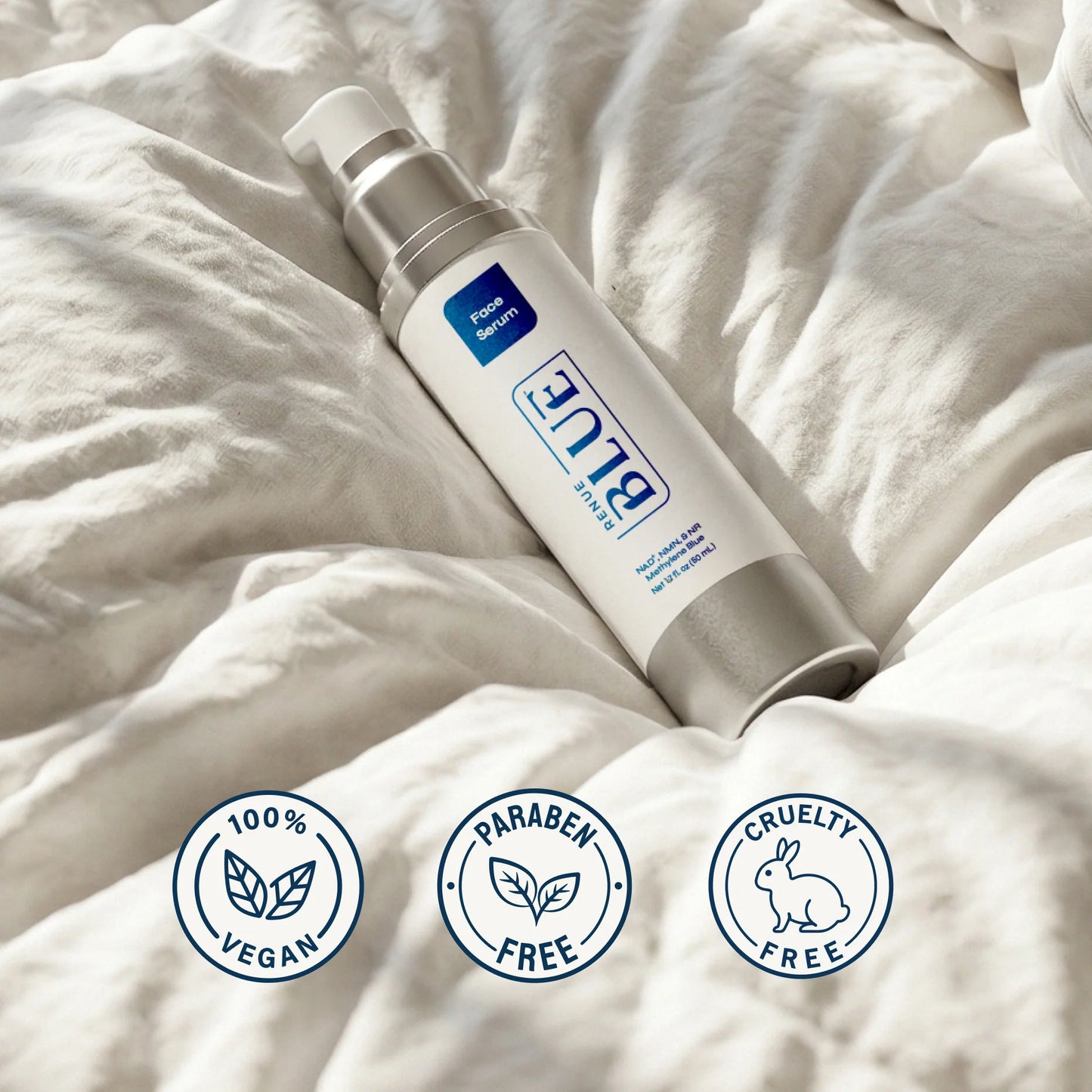 Skincare bottle with 'Blue' branding on a textured beige fabric background, featuring vegan, paraben-free, and cruelty-free icons.